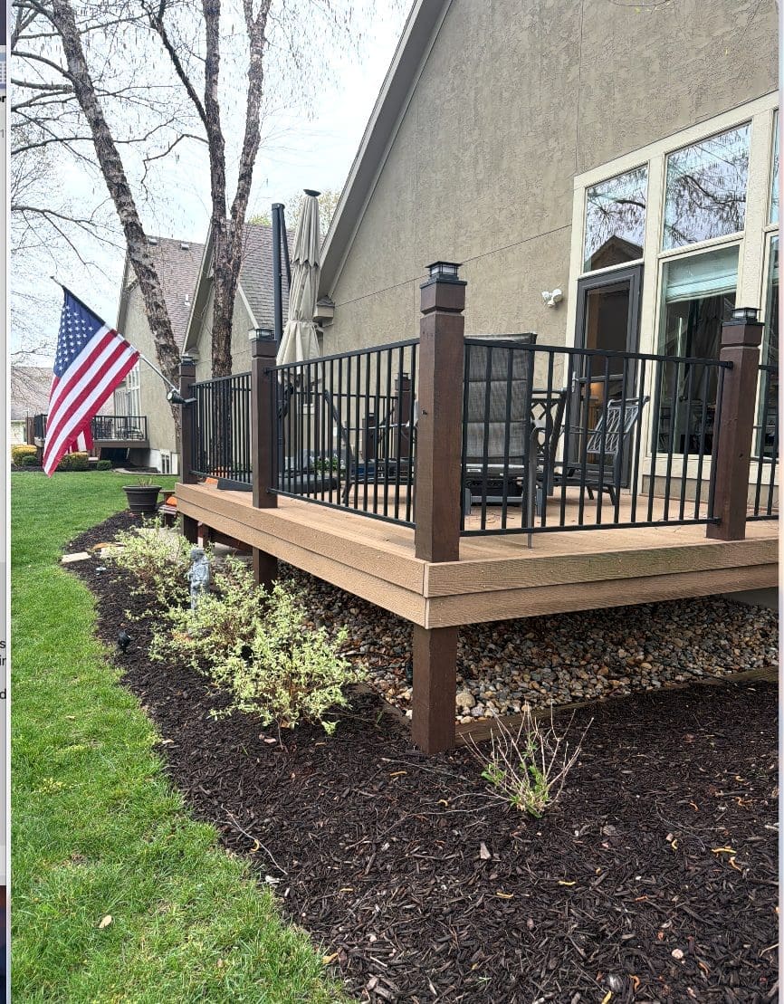Existing composite deck with black metal railing at a Shawnee, KS home in Johnson County